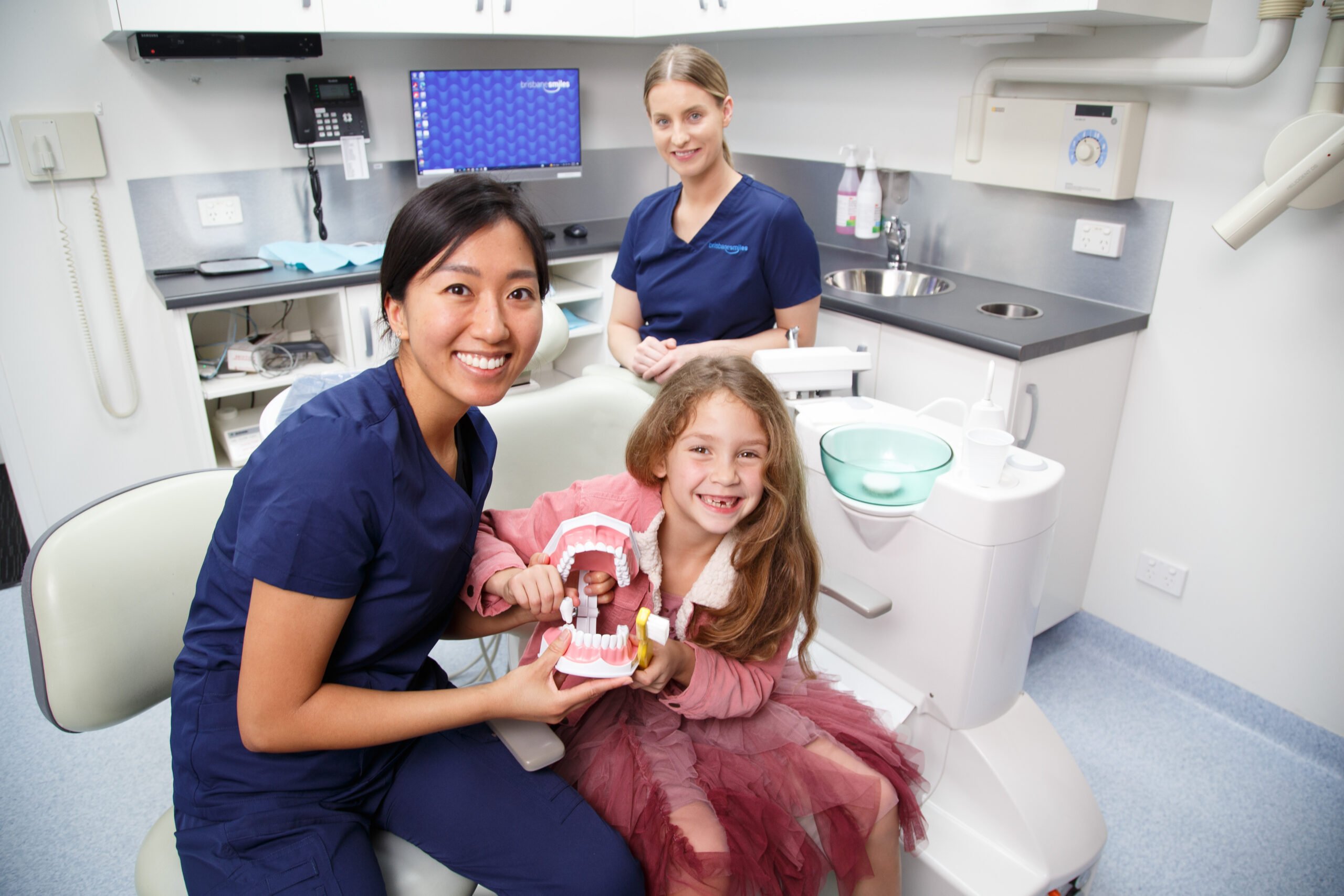 oral health therapist with child dentist